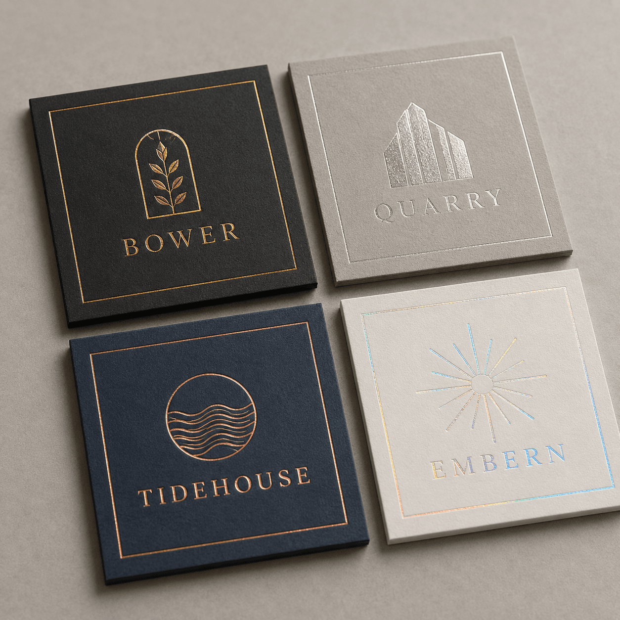 Gold, silver and coloured foil logos stamped onto paperboard samples with crisp edges and strong contrast.
