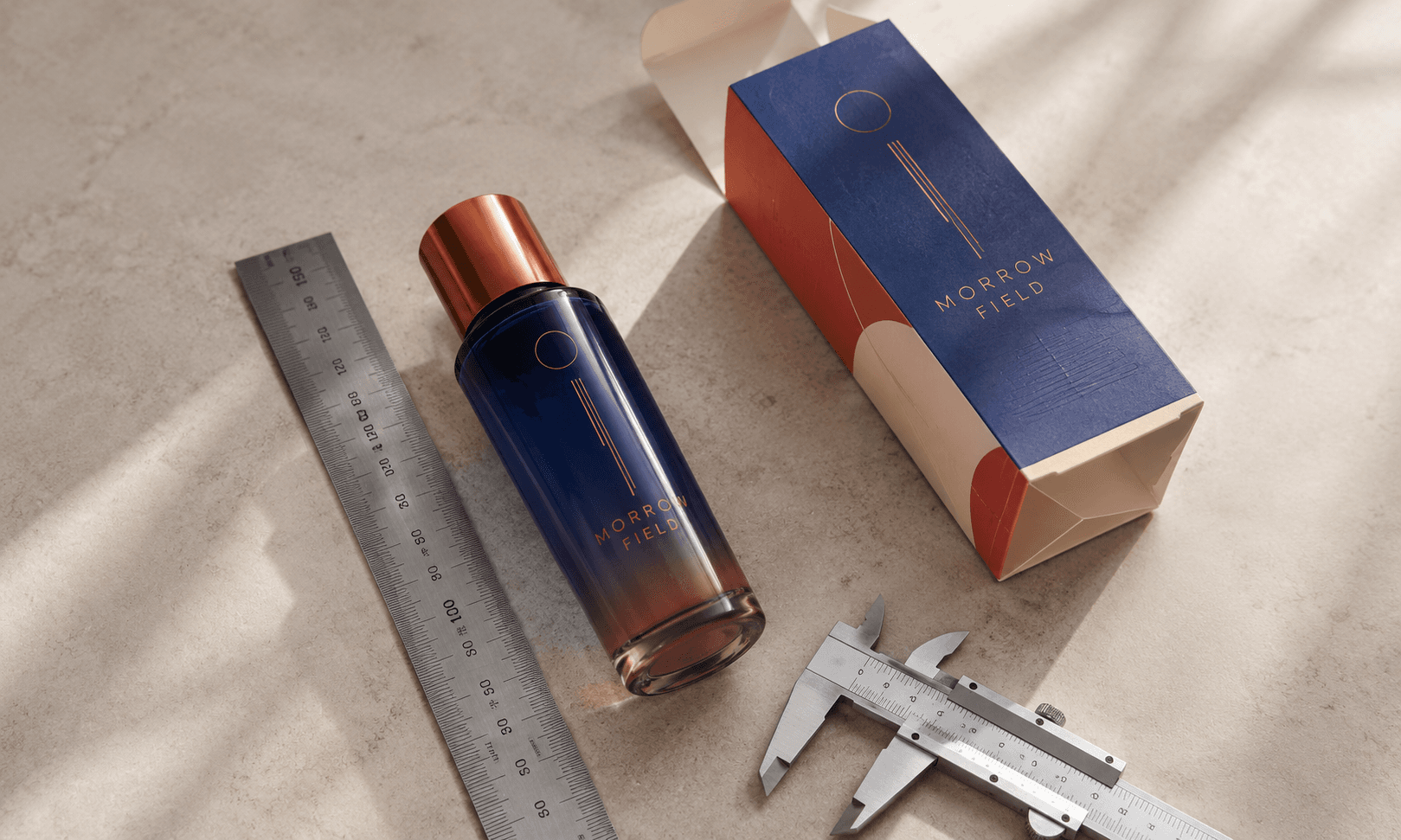 Custom skincare bottle beside an open folding carton, steel ruler and callipers on a refined studio surface.