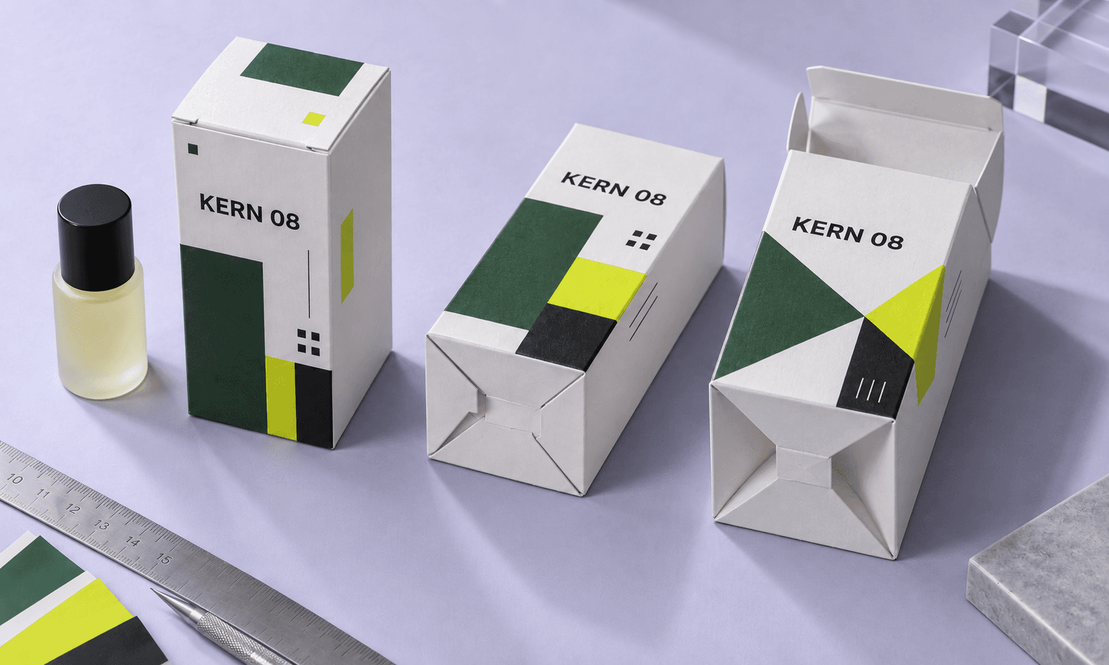 Three folding cartons compare tuck end, snap lock and auto lock bottom structures on a packaging approval bench.