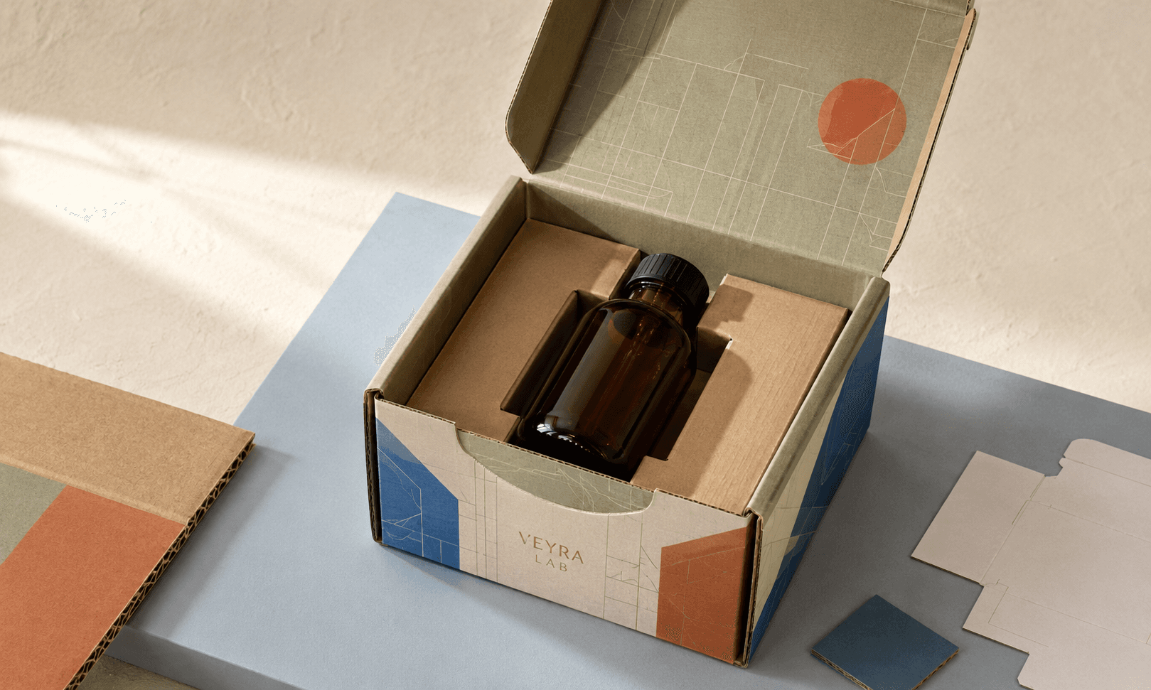 Custom packaging decision still life with a product, fitted mailer, board samples and structural prototype.