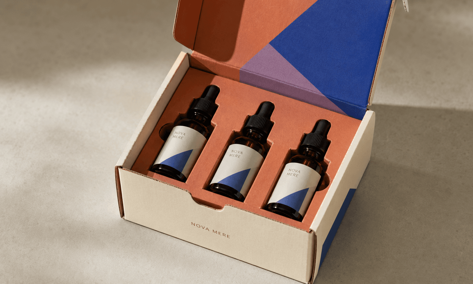 Open printed ecommerce mailer with serum bottles held in a fitted insert and a bold interior reveal